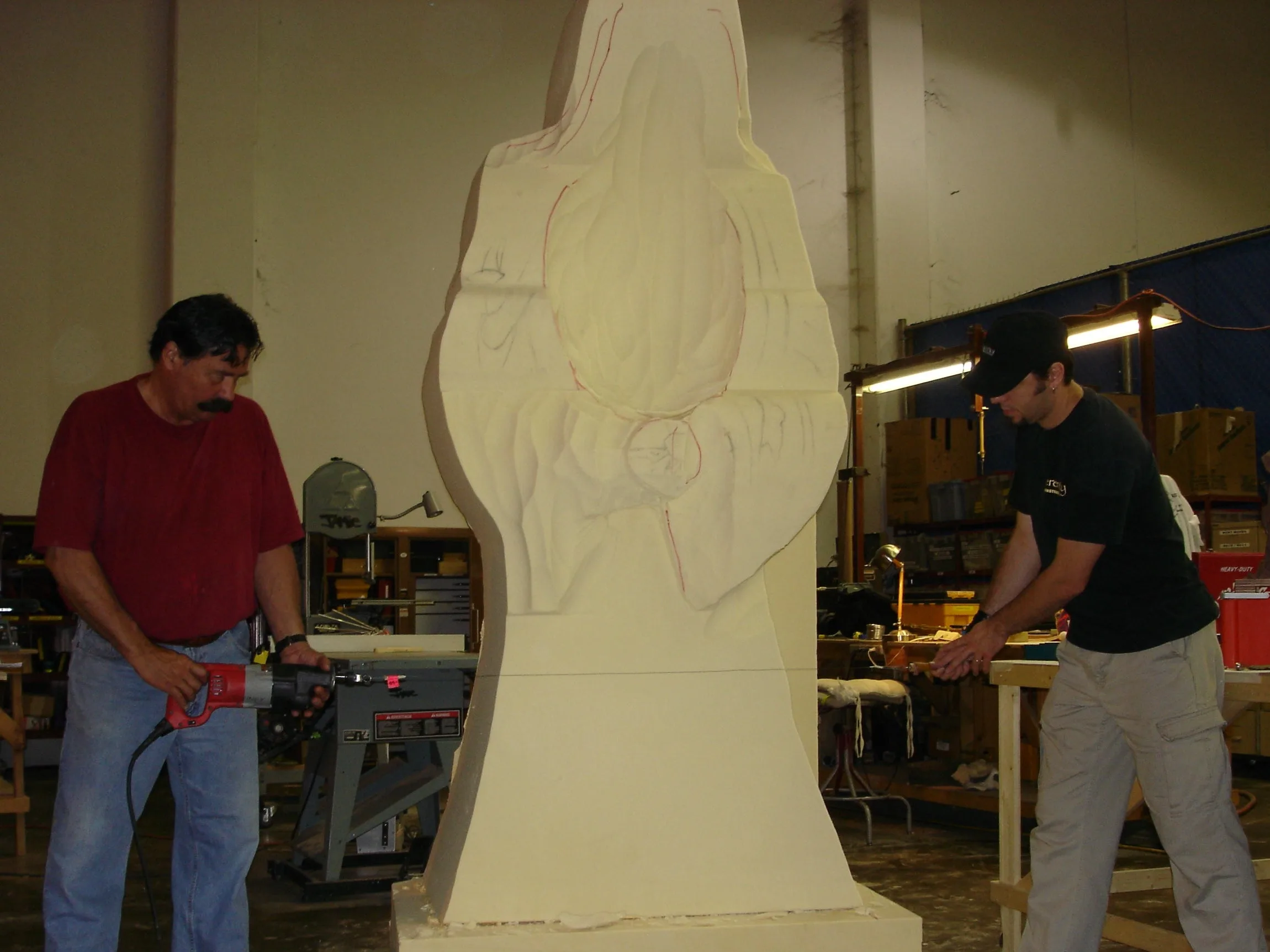 Urethane foam sculptor cutting a shaped piece with a Spyral reciprocating blade